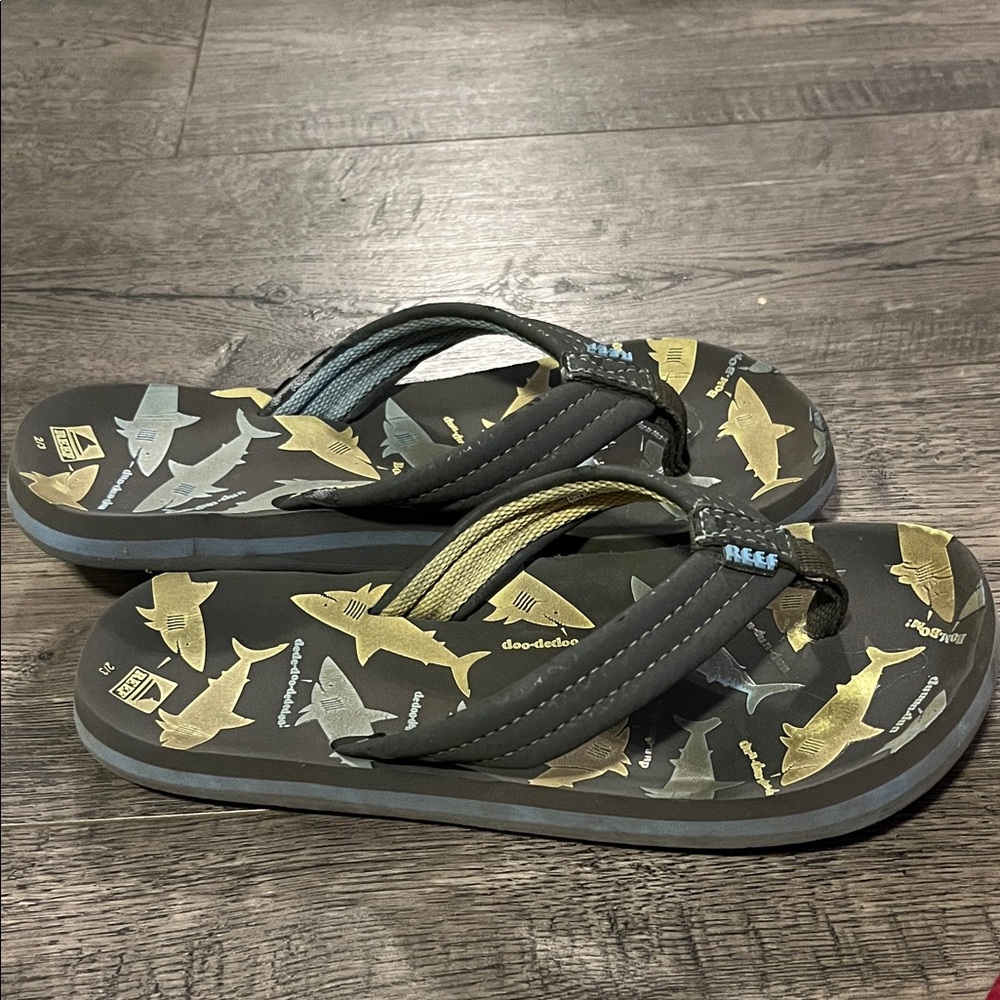 Reef Black Flip Flops with Gold and Silver Shark Print